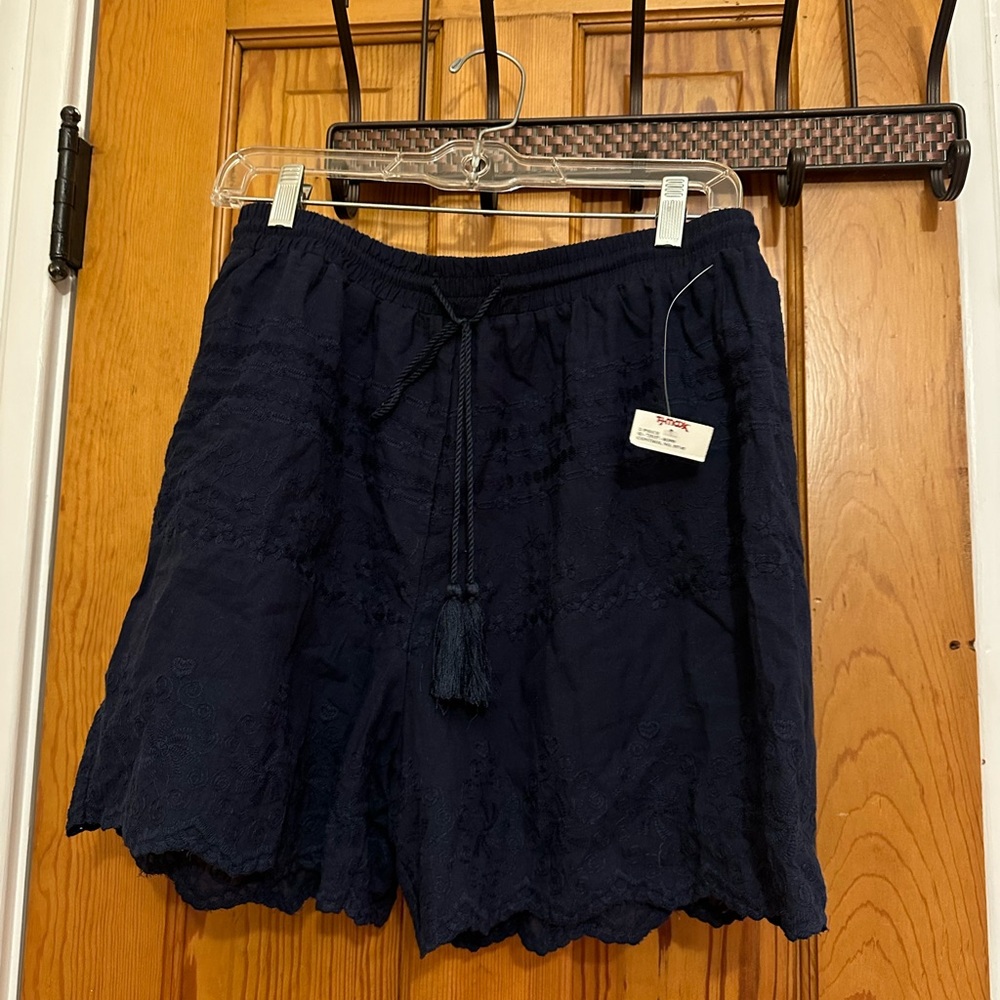 Two piece set.Never been worn. Tags on. Shorts and button down top. Large.